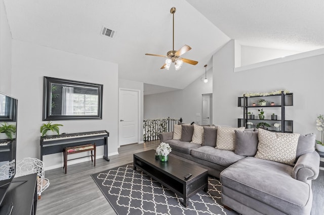 16603 April Hill St, Houston, TX 77095 - living area featuring ceiling fan, wood finished floors, high vaulted ceiling, and baseboards