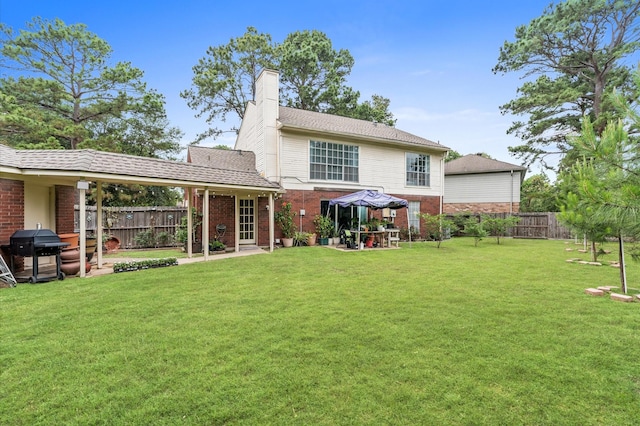 16603 April Hill St, Houston, TX 77095 - back of house featuring brick siding, a chimney, and a patio area