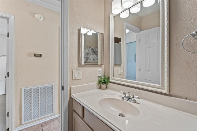 9302 Kirkchapel Ct, Spring, TX 77379 - bathroom with a textured wall, vanity, and tile patterned floors