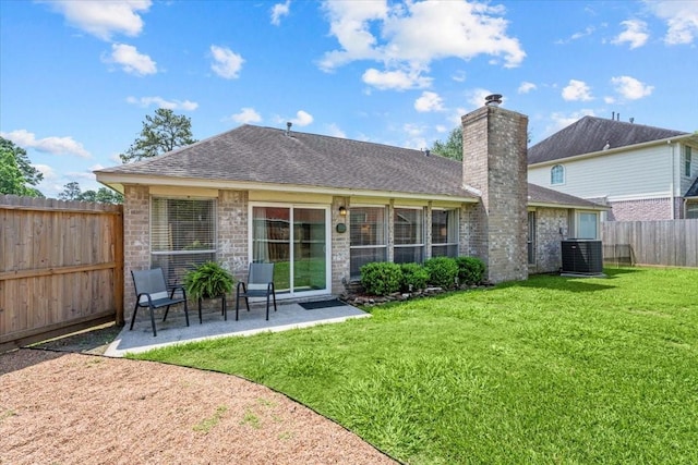 9302 Kirkchapel Ct, Spring, TX 77379 - back of property with a patio area, central AC, a shingled roof, a chimney, and brick siding
