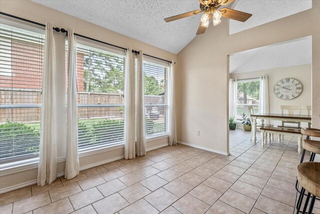 9302 Kirkchapel Ct, Spring, TX 77379 - unfurnished room with lofted ceiling, a textured ceiling, a ceiling fan, light tile patterned flooring, and baseboards
