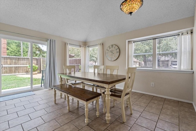 9302 Kirkchapel Ct, Spring, TX 77379 - tiled dining area featuring a textured ceiling and baseboards