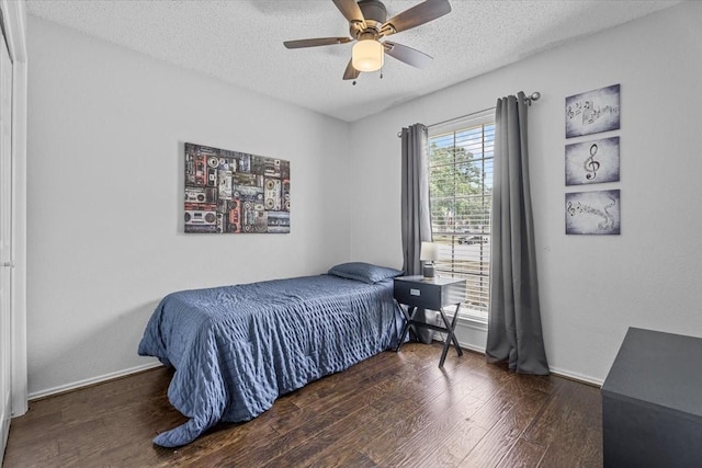 9302 Kirkchapel Ct, Spring, TX 77379 - bedroom featuring a textured ceiling, wood finished floors, and a ceiling fan