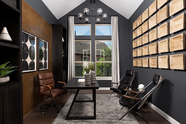 living area with wood finished floors, baseboards, vaulted ceiling, and a chandelier