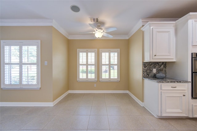 2007 N Greens Blvd, Richmond, TX 77406 - kitchen with plenty of natural light, ceiling fan, dark stone countertops, crown molding, and white cabinetry