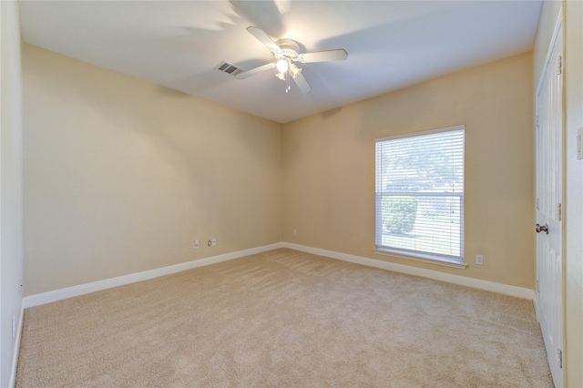 2007 N Greens Blvd, Richmond, TX 77406 - spare room featuring light carpet, baseboards, and ceiling fan