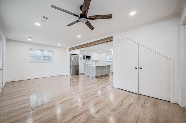 1739 Nocturne Ln, Houston, TX 77043 - unfurnished living room with crown molding, ceiling fan, light wood-type flooring, recessed lighting, and baseboards