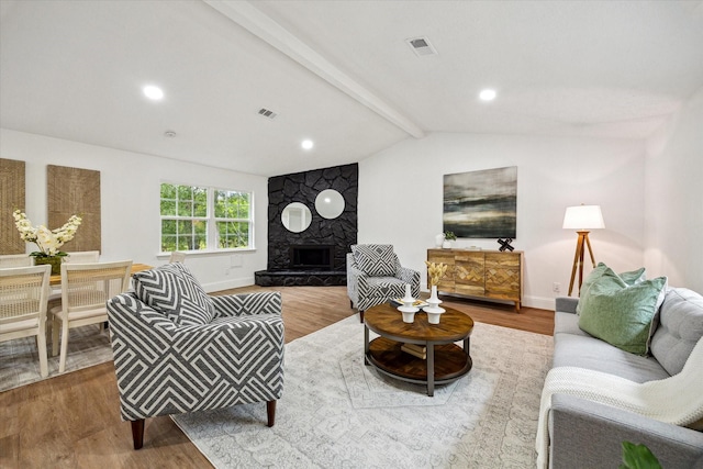 living room with wood finished floors, baseboards, and a fireplace
