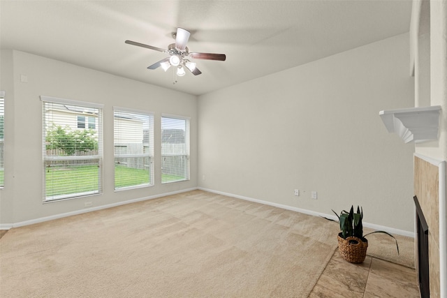 15010 Calico Heights Ln, Cypress, TX 77433 - unfurnished living room with ceiling fan, baseboards, and light carpet