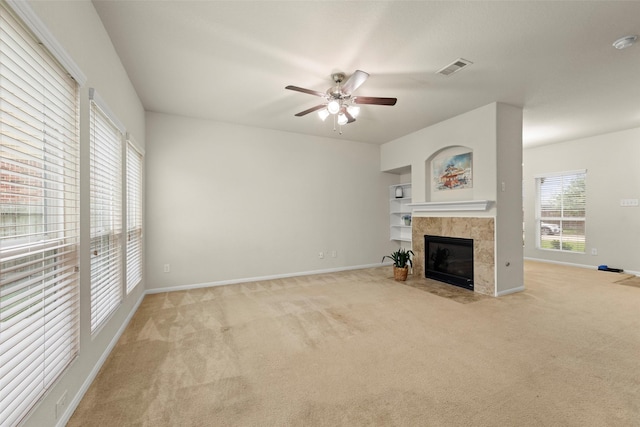 15010 Calico Heights Ln, Cypress, TX 77433 - unfurnished living room featuring ceiling fan, baseboards, light colored carpet, and a fireplace