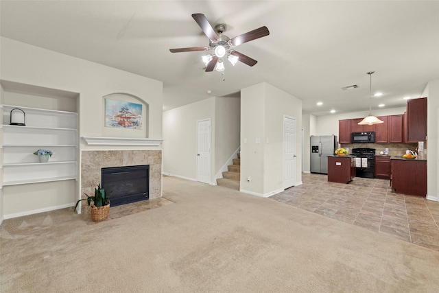 15010 Calico Heights Ln, Cypress, TX 77433 - living area with light carpet, stairway, baseboards, ceiling fan, and a fireplace
