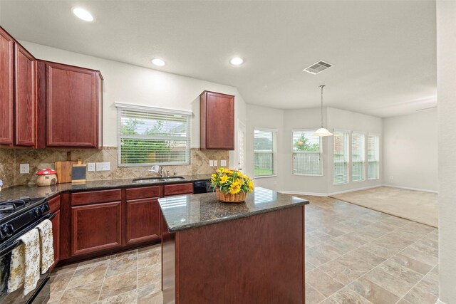 15010 Calico Heights Ln, Cypress, TX 77433 - kitchen with a sink, black gas range oven, healthy amount of natural light, backsplash, and recessed lighting