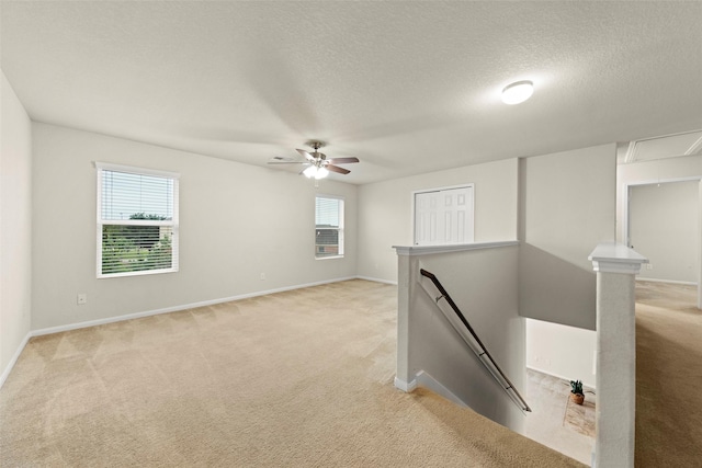 15010 Calico Heights Ln, Cypress, TX 77433 - empty room with attic access, plenty of natural light, light carpet, ceiling fan, and a textured ceiling