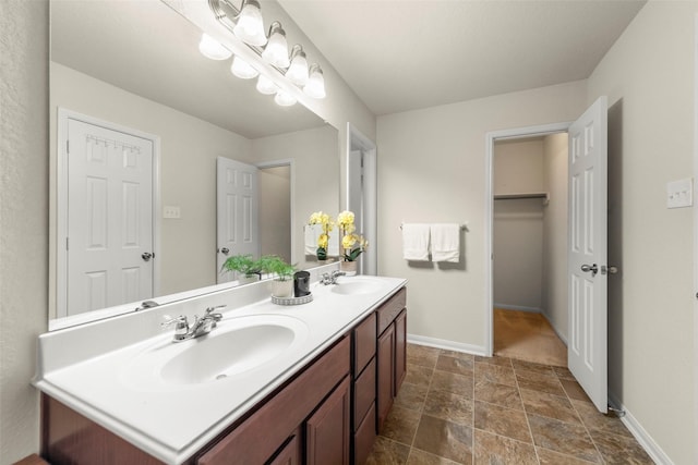 15010 Calico Heights Ln, Cypress, TX 77433 - full bathroom with stone finish flooring, baseboards, and double vanity