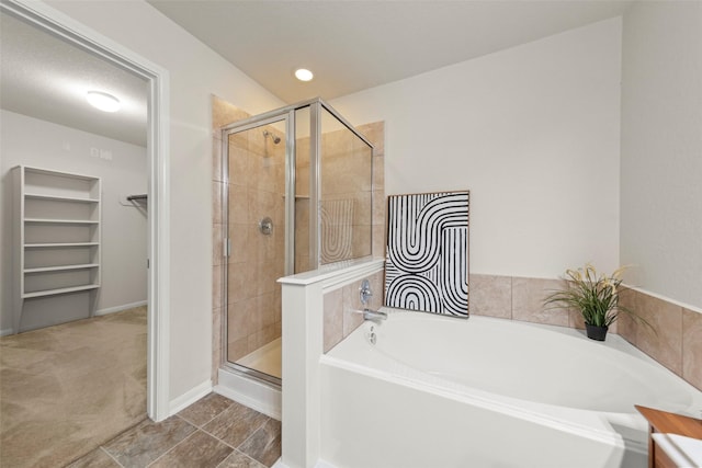 15010 Calico Heights Ln, Cypress, TX 77433 - full bathroom with a stall shower, a garden tub, a spacious closet, and baseboards
