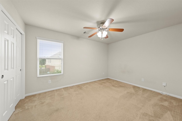 15010 Calico Heights Ln, Cypress, TX 77433 - unfurnished bedroom featuring light carpet, baseboards, a closet, and a ceiling fan