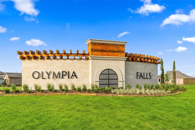 community sign featuring a yard