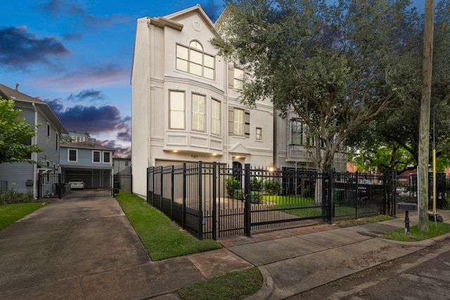 view of property with stucco siding, a gate, and a fenced front yard