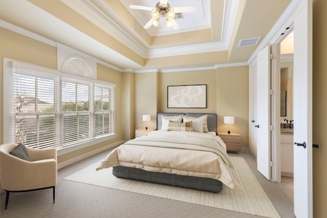 bedroom featuring a raised ceiling, crown molding, baseboards, ceiling fan, and light colored carpet