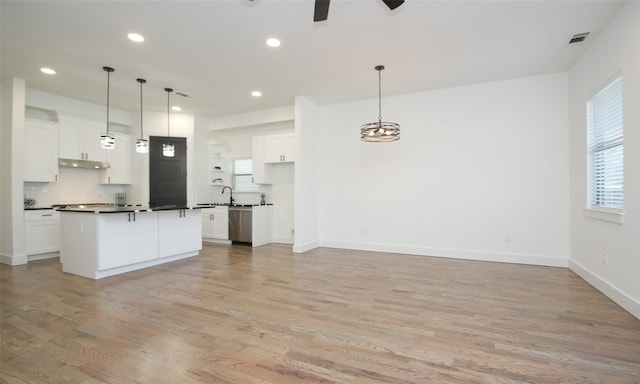 1224 Johnston St, Houston, TX 77022 - kitchen featuring stainless steel dishwasher, ceiling fan, light wood finished floors, dark countertops, and white cabinets