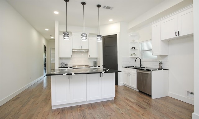 1224 Johnston St, Houston, TX 77022 - kitchen with stainless steel dishwasher, dark countertops, backsplash, open shelves, and white cabinets