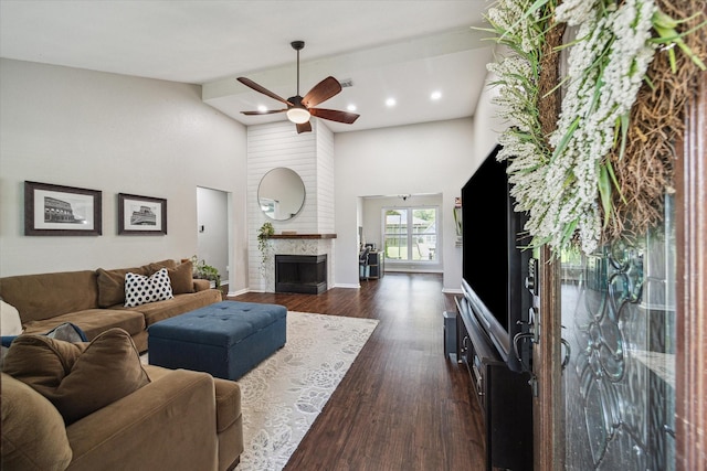 living area featuring ceiling fan, dark wood finished floors, a fireplace, recessed lighting, and high vaulted ceiling