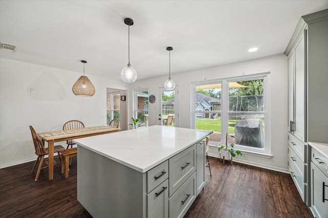 kitchen featuring dark wood-style floors, baseboards, gray cabinetry, a center island, and recessed lighting