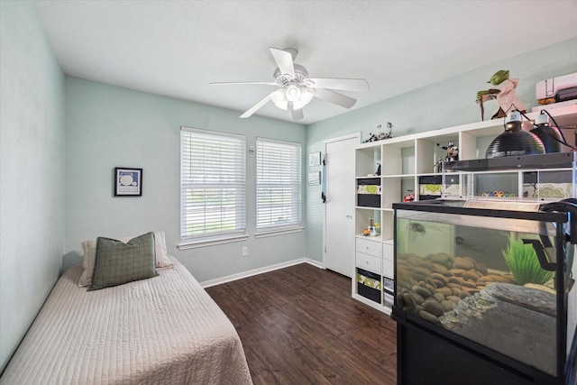 bedroom featuring wood finished floors, baseboards, and ceiling fan