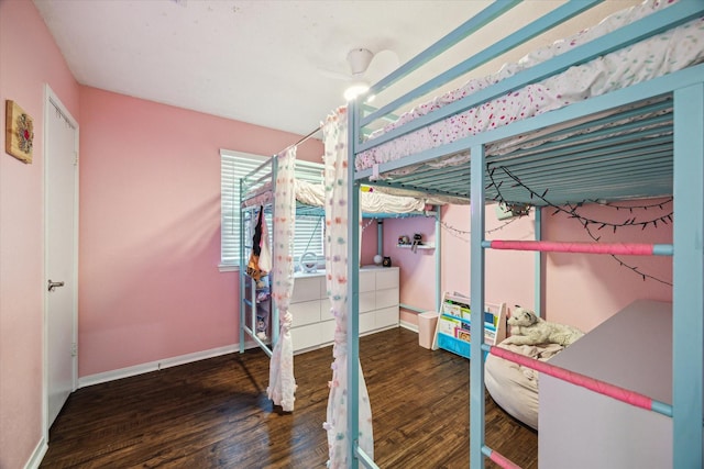 bedroom with wood finished floors and baseboards