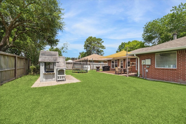 view of yard featuring a patio area, an outdoor structure, and a storage shed