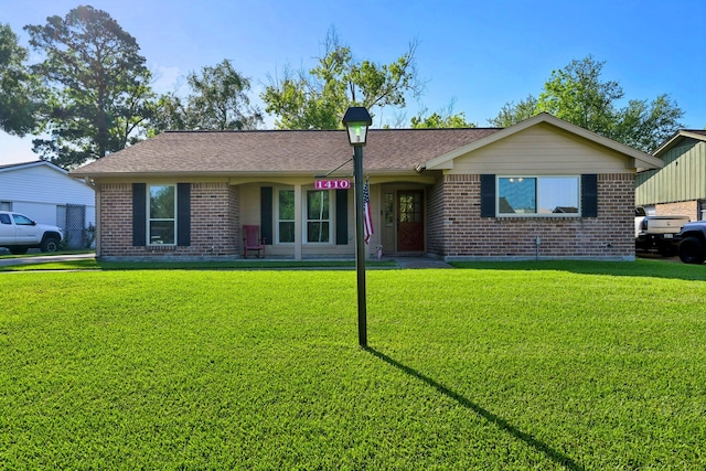 1410 Saxony Ln, Nassau Bay, TX 77058 - ranch-style home featuring brick siding and a front lawn