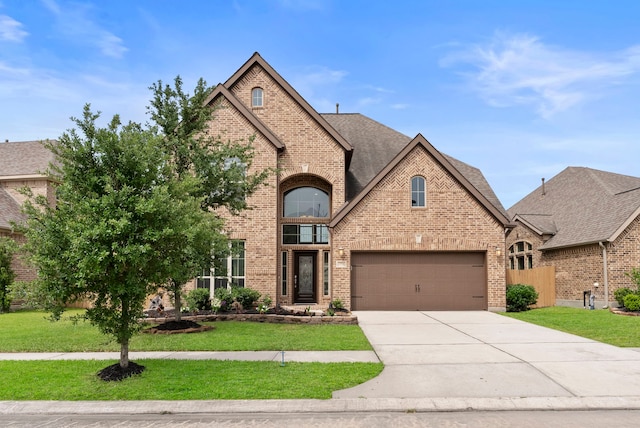 27935 Chiapas Dr, Spring, TX 77386 - french country inspired facade featuring brick siding, concrete driveway, an attached garage, and a shingled roof