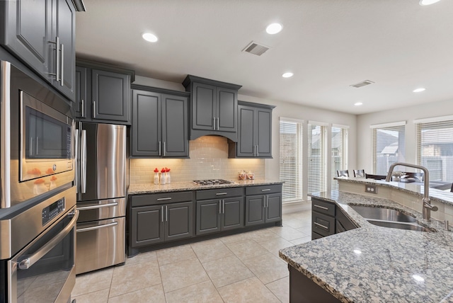27935 Chiapas Dr, Spring, TX 77386 - kitchen featuring a sink, appliances with stainless steel finishes, plenty of natural light, tasteful backsplash, and recessed lighting