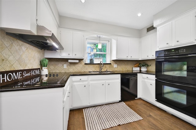 12443 Honeywood Trl, Houston, TX 77077 - kitchen featuring black appliances, wall chimney exhaust hood, a sink, dark countertops, and white cabinetry