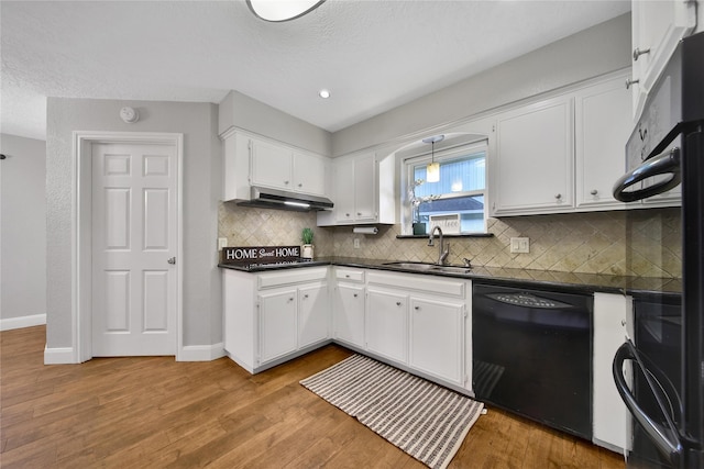 12443 Honeywood Trl, Houston, TX 77077 - kitchen featuring black appliances, a sink, dark countertops, under cabinet range hood, and recessed lighting