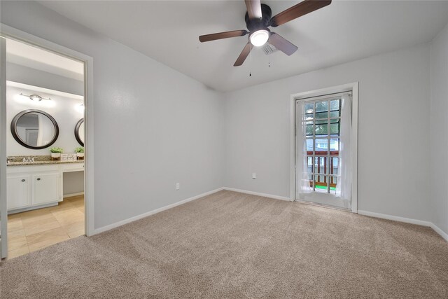 12443 Honeywood Trl, Houston, TX 77077 - unfurnished bedroom featuring light colored carpet, baseboards, connected bathroom, and a sink