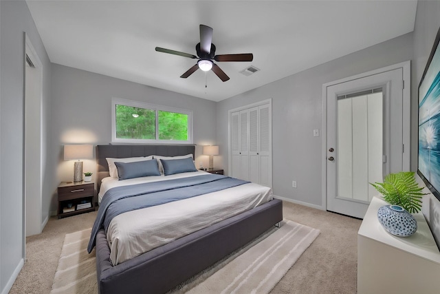 12443 Honeywood Trl, Houston, TX 77077 - bedroom with light carpet, baseboards, a ceiling fan, and a closet