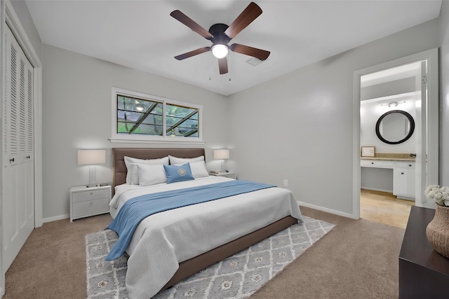 12443 Honeywood Trl, Houston, TX 77077 - bedroom with carpet, a closet, baseboards, ensuite bathroom, and ceiling fan