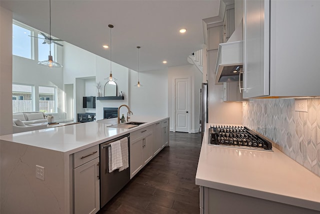 29851 Aaron River Trl, Fulshear, TX 77441 - kitchen with a sink, appliances with stainless steel finishes, open floor plan, light countertops, and dark wood-style floors