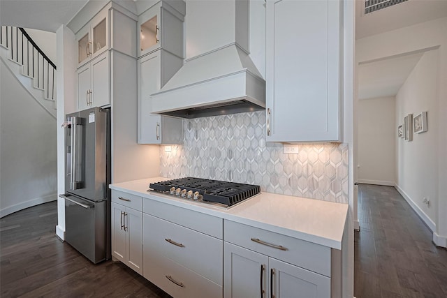 29851 Aaron River Trl, Fulshear, TX 77441 - kitchen featuring appliances with stainless steel finishes, premium range hood, dark wood finished floors, and backsplash