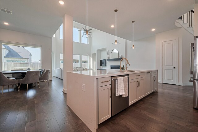 29851 Aaron River Trl, Fulshear, TX 77441 - kitchen featuring a sink, dishwasher, open floor plan, dark wood finished floors, and a high ceiling