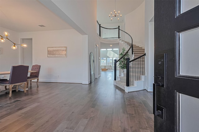 29851 Aaron River Trl, Fulshear, TX 77441 - entrance foyer featuring a chandelier, stairs, dark wood-style floors, a high ceiling, and baseboards
