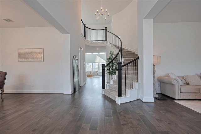 29851 Aaron River Trl, Fulshear, TX 77441 - entryway with dark wood-style floors, a high ceiling, stairs, a chandelier, and baseboards