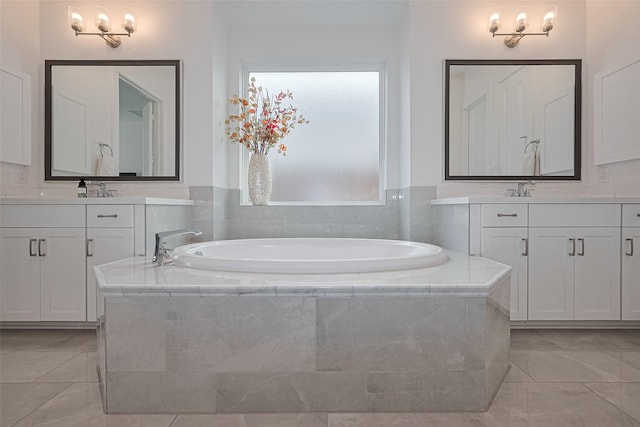 29851 Aaron River Trl, Fulshear, TX 77441 - full bathroom featuring two vanities, a garden tub, and marble finish flooring
