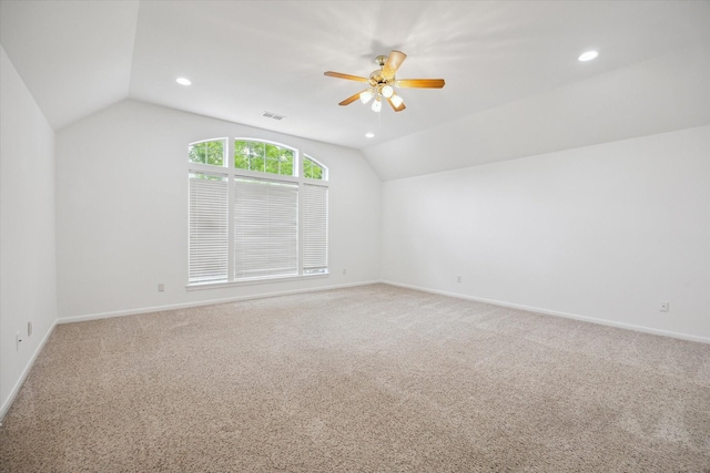 spare room with lofted ceiling, light carpet, recessed lighting, ceiling fan, and baseboards