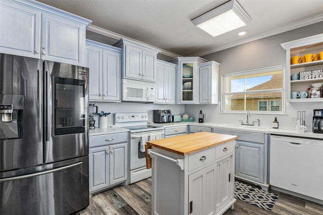 2296 Martinique, Crystal Beach, TX 77650 - kitchen with white appliances, a sink, butcher block countertops, ornamental molding, and dark wood finished floors