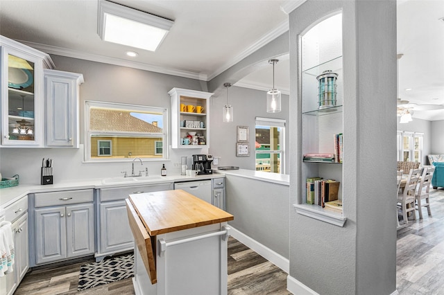 2296 Martinique, Crystal Beach, TX 77650 - kitchen featuring wooden counters, a sink, ornamental molding, glass insert cabinets, and dishwasher