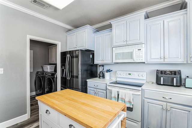 2296 Martinique, Crystal Beach, TX 77650 - kitchen with white appliances, independent washer and dryer, ornamental molding, butcher block counters, and baseboards