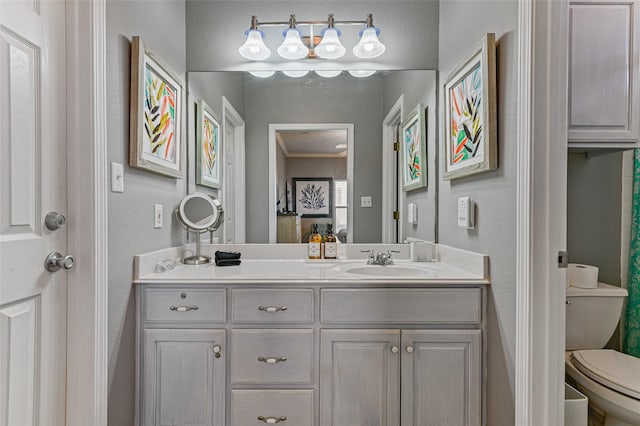 2296 Martinique, Crystal Beach, TX 77650 - bathroom with vanity, toilet, and a textured wall