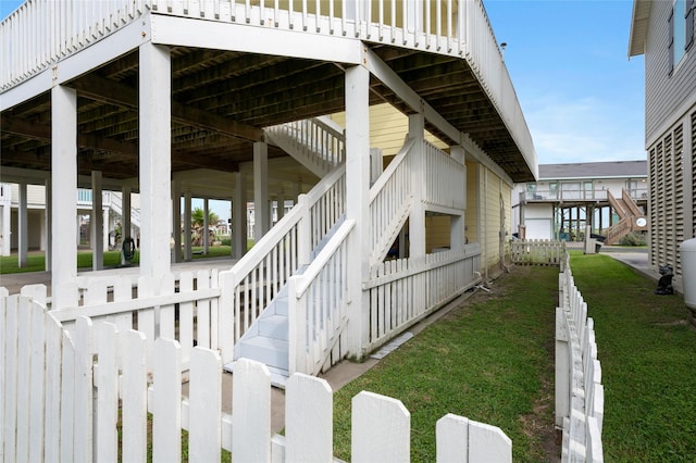 2296 Martinique, Crystal Beach, TX 77650 - view of side of home with stairs and a lawn